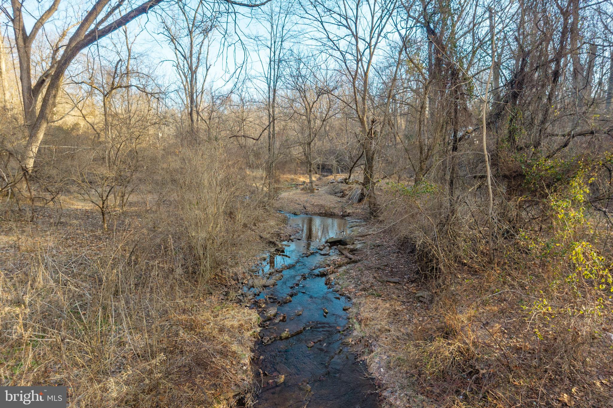 0 Sanatoga Road, Unit B Pottstown, PA 19464 - Photo 31 of 42 Serene stream winding through bare trees.
