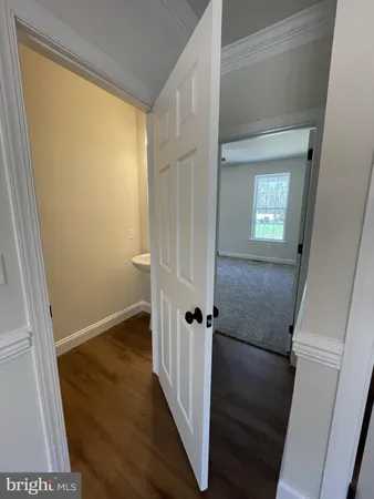an empty room with closet and a ceiling fan