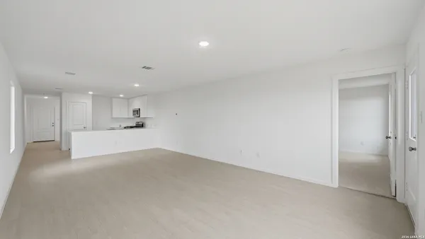 a view of a kitchen with a sink and a refrigerator