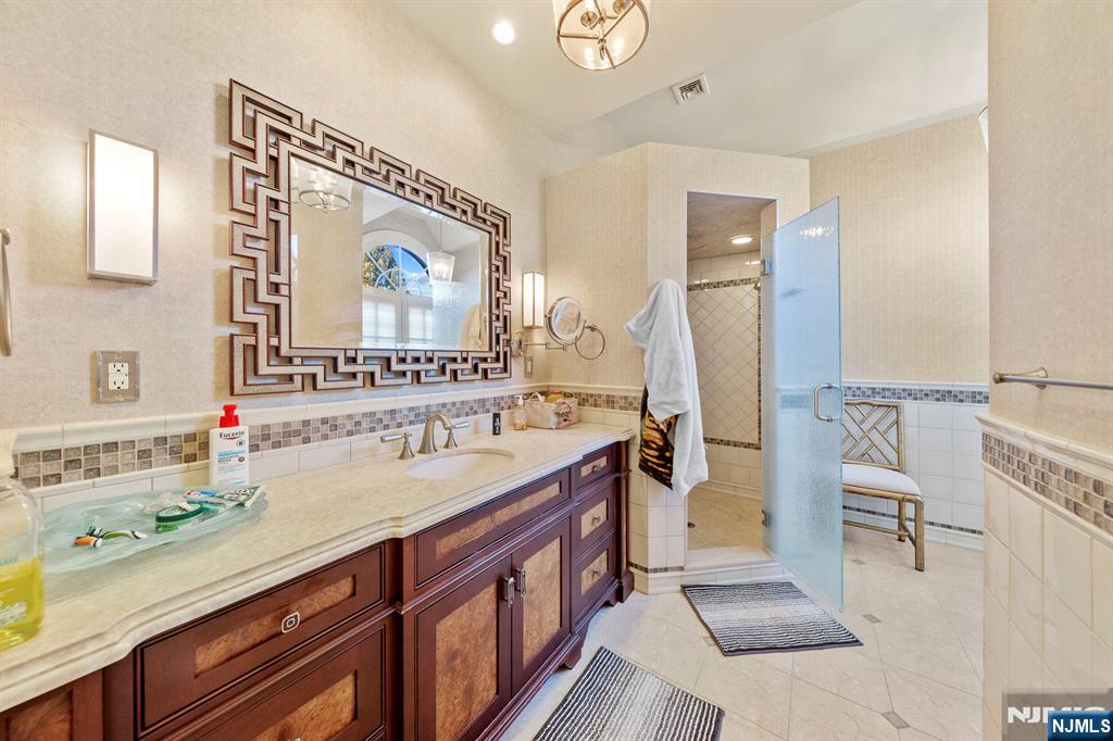 78 Roberts Road Englewood Cliffs, NJ 07632 - Photo 32 of 50 a bathroom with a sink a mirror and a bathtub