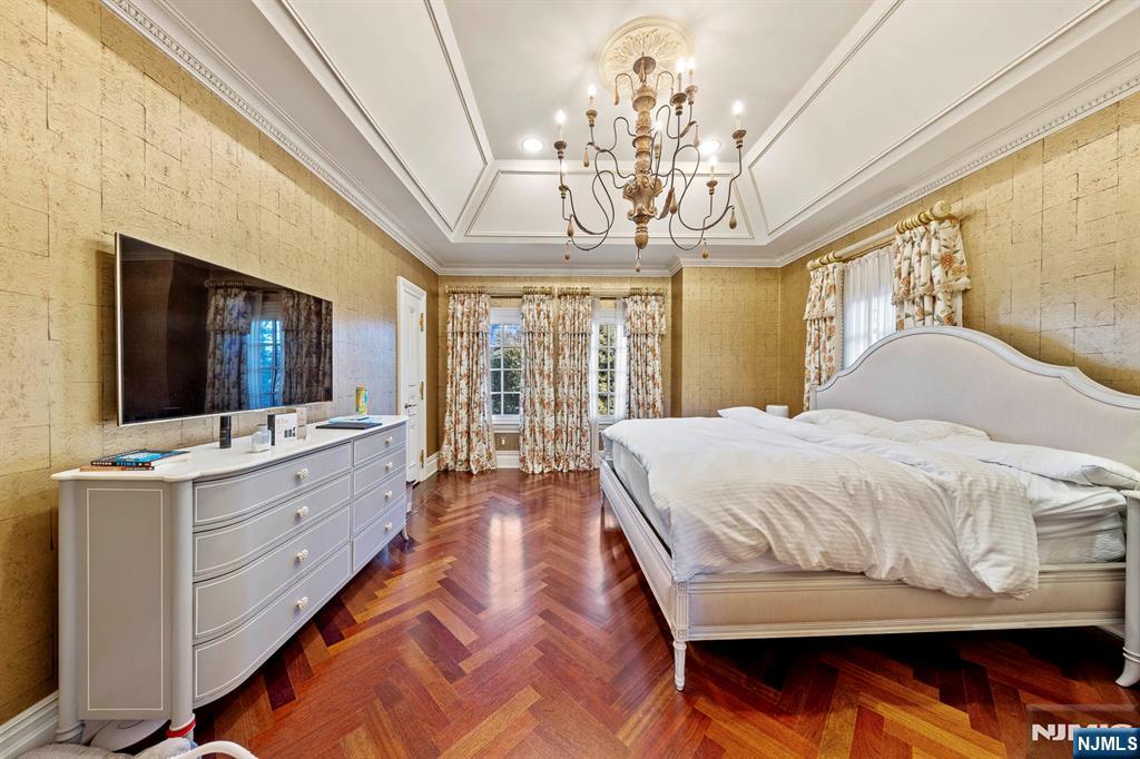 78 Roberts Road Englewood Cliffs, NJ 07632 - Photo 35 of 50 a spacious bedroom with a large bed and a flat tv screen on dresser