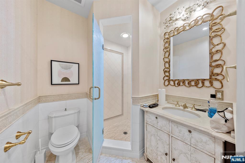 78 Roberts Road Englewood Cliffs, NJ 07632 - Photo 36 of 50 a bathroom with a sink a toilet and a mirror