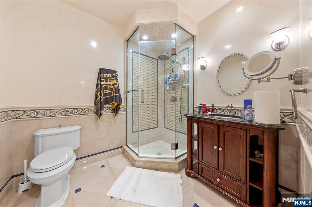 78 Roberts Road Englewood Cliffs, NJ 07632 - Photo 41 of 50 a bathroom with a toilet a sink and a mirror
