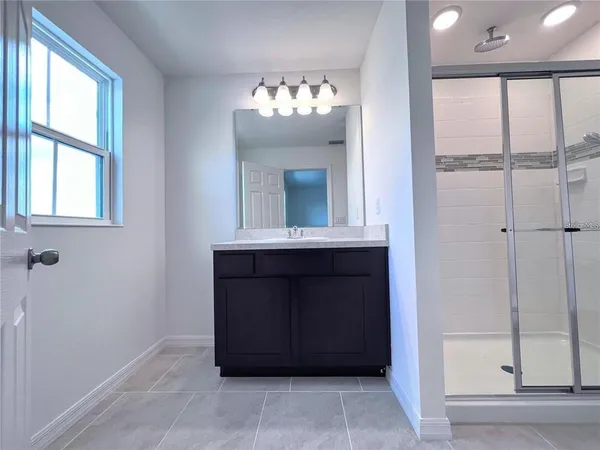 a bathroom with a mirror and a shower
