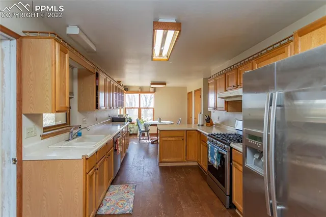 a kitchen with a sink stove and refrigerator
