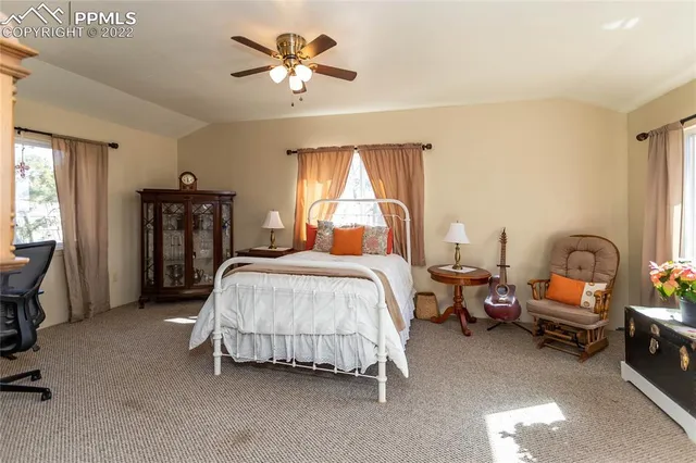 a spacious bedroom with a bed and a chandelier