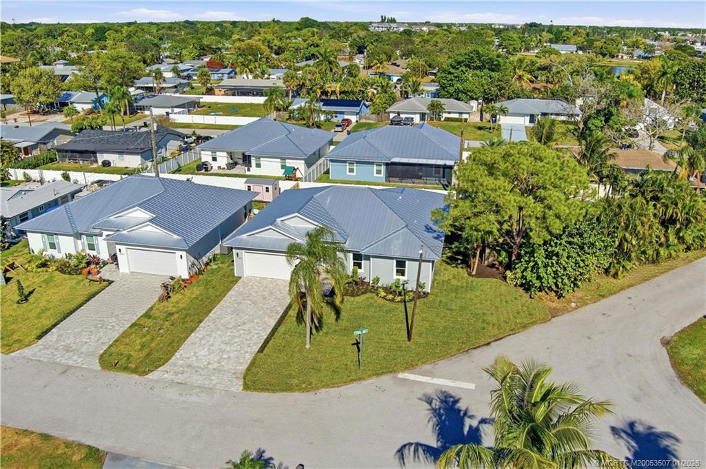 1063 Northwest 12th Terrace Stuart, FL 34994 - Photo 11 of 42 an aerial view of residential houses with outdoor space and parking