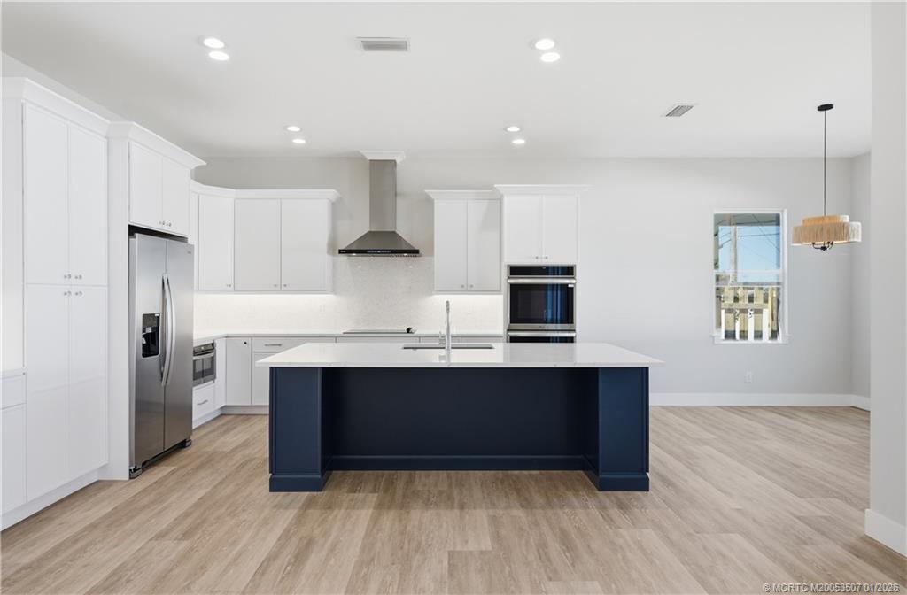 1063 Northwest 12th Terrace Stuart, FL 34994 - Photo 15 of 42 a view of kitchen with wooden floor and electronic appliances