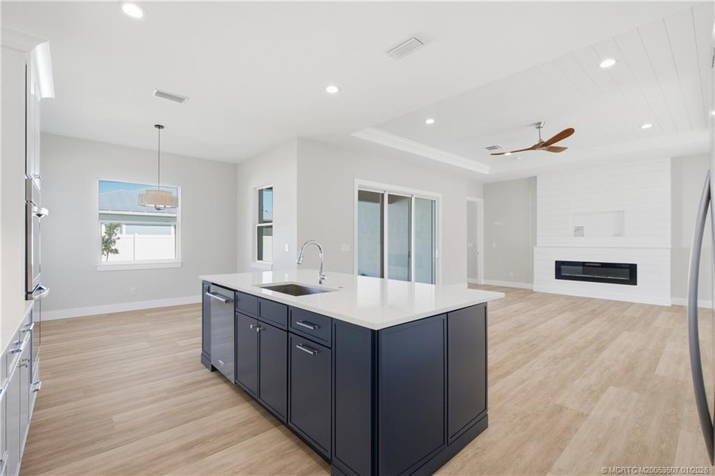1063 Northwest 12th Terrace Stuart, FL 34994 - Photo 18 of 42 a large kitchen with stainless steel appliances a large counter top a sink a refrigerator and a window