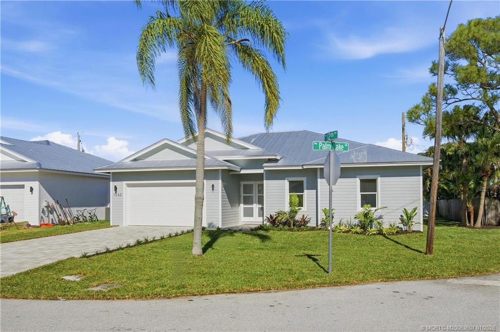 1063 Northwest 12th Terrace Stuart, FL 34994 - Photo 2 of 42 a front view of house with yard and green space