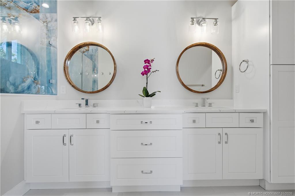 1063 Northwest 12th Terrace Stuart, FL 34994 - Photo 26 of 42 a bathroom with a sink and a mirror