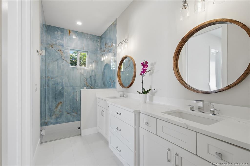 1063 Northwest 12th Terrace Stuart, FL 34994 - Photo 27 of 42 a bathroom with a sink and a mirror