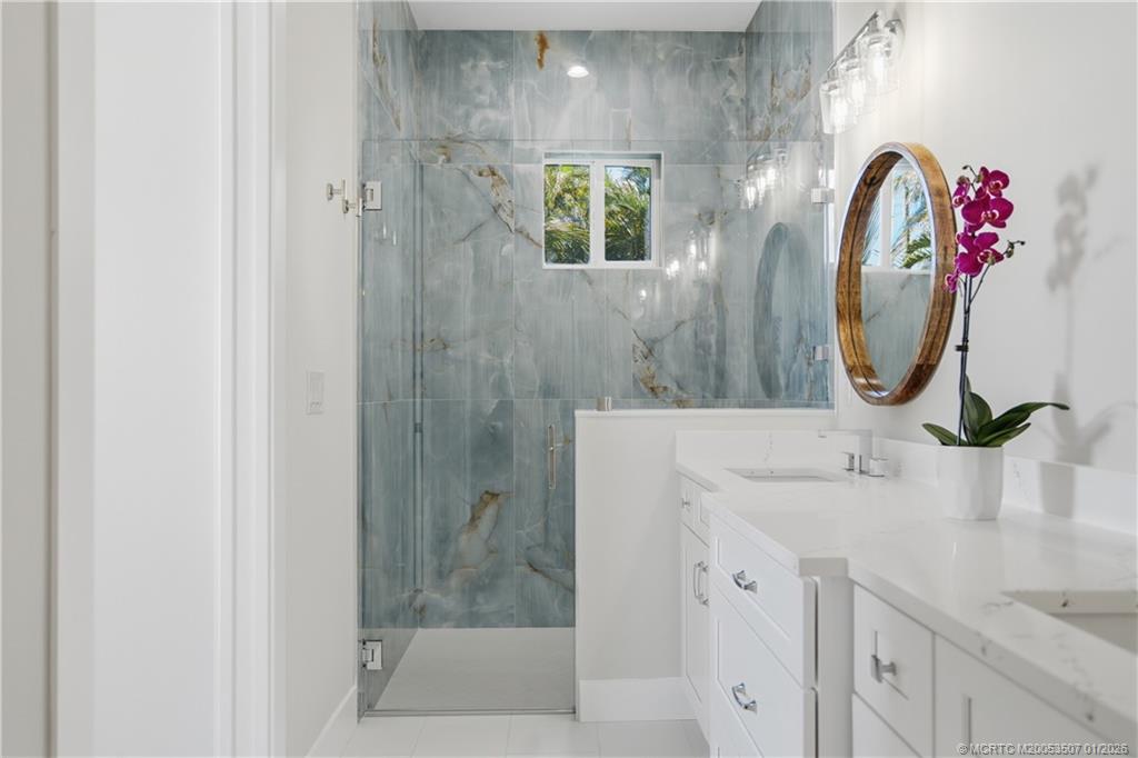 1063 Northwest 12th Terrace Stuart, FL 34994 - Photo 28 of 42 a bathroom with a sink and a mirror