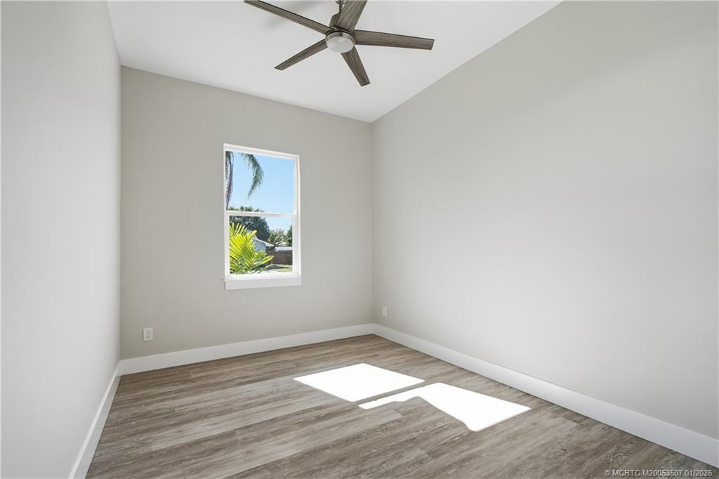 1063 Northwest 12th Terrace Stuart, FL 34994 - Photo 29 of 42 an empty room with a window and a ceiling fan