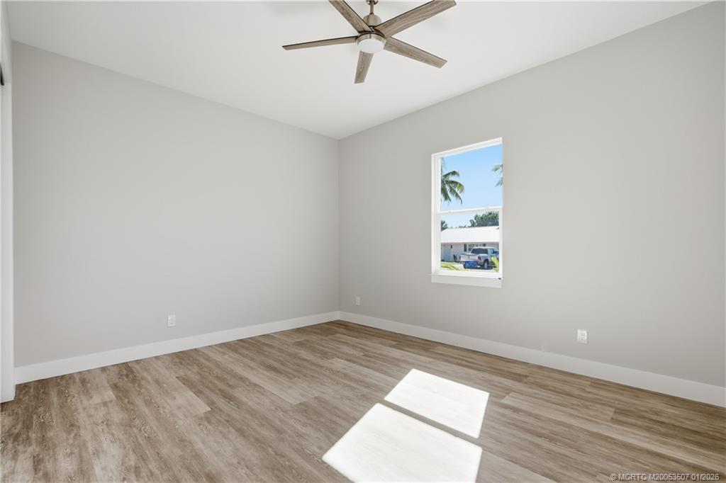 1063 Northwest 12th Terrace Stuart, FL 34994 - Photo 31 of 42 an empty room with a window and a fan