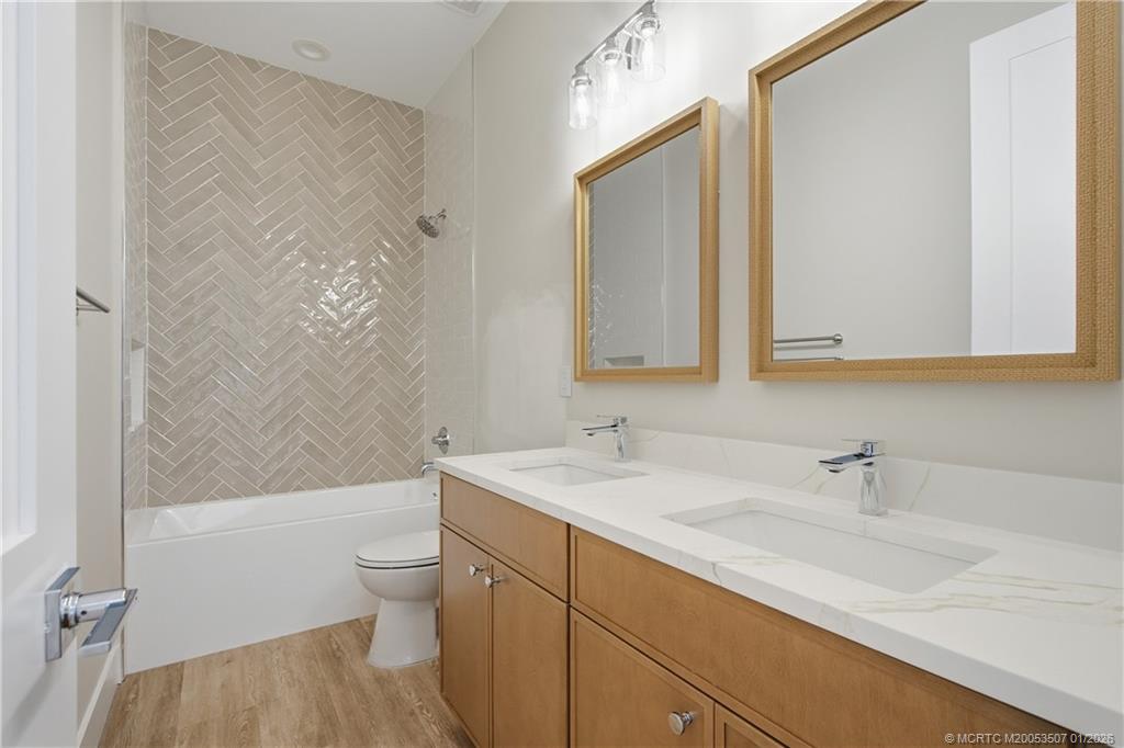 1063 Northwest 12th Terrace Stuart, FL 34994 - Photo 33 of 42 a bathroom with a sink a toilet and shower