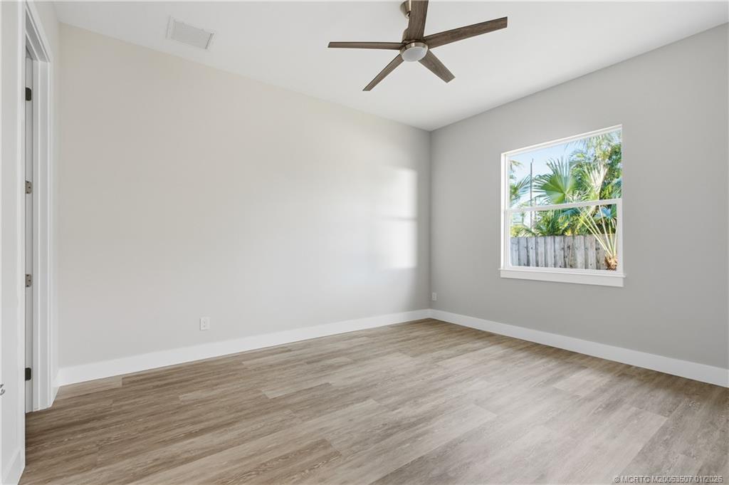 1063 Northwest 12th Terrace Stuart, FL 34994 - Photo 34 of 42 a view of room with hardwood floor and window