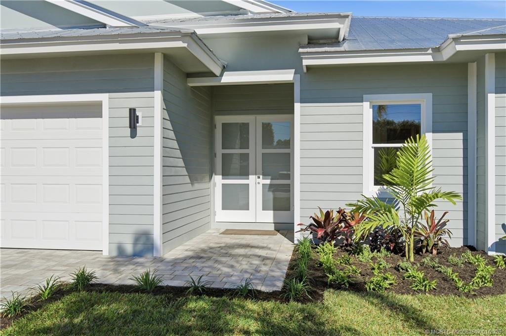 1063 Northwest 12th Terrace Stuart, FL 34994 - Photo 4 of 42 a front view of a house with garden
