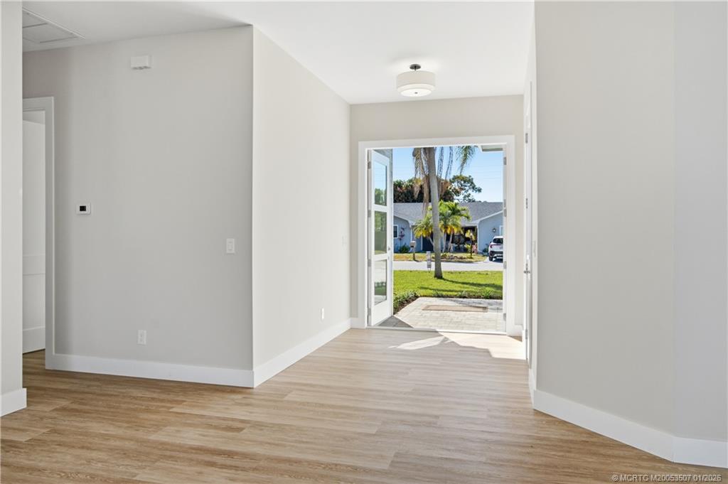 1063 Northwest 12th Terrace Stuart, FL 34994 - Photo 6 of 42 a view of a bedroom with wooden floor