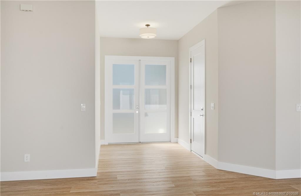 1063 Northwest 12th Terrace Stuart, FL 34994 - Photo 7 of 42 a view of an empty room with wooden floor
