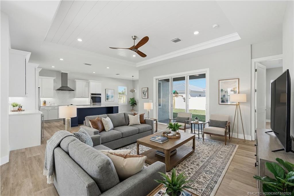 1063 Northwest 12th Terrace Stuart, FL 34994 - Photo 8 of 42 a living room with fireplace furniture and a flat screen tv