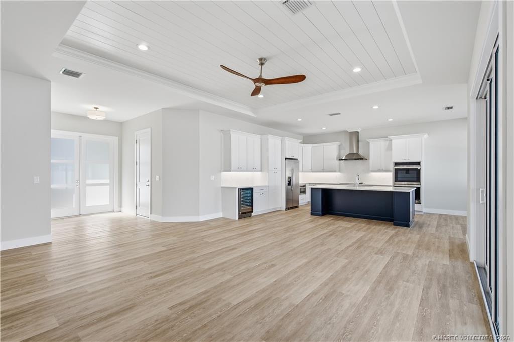 1063 Northwest 12th Terrace Stuart, FL 34994 - Photo 9 of 42 a view of a kitchen with kitchen island wooden floor and stainless steel appliances