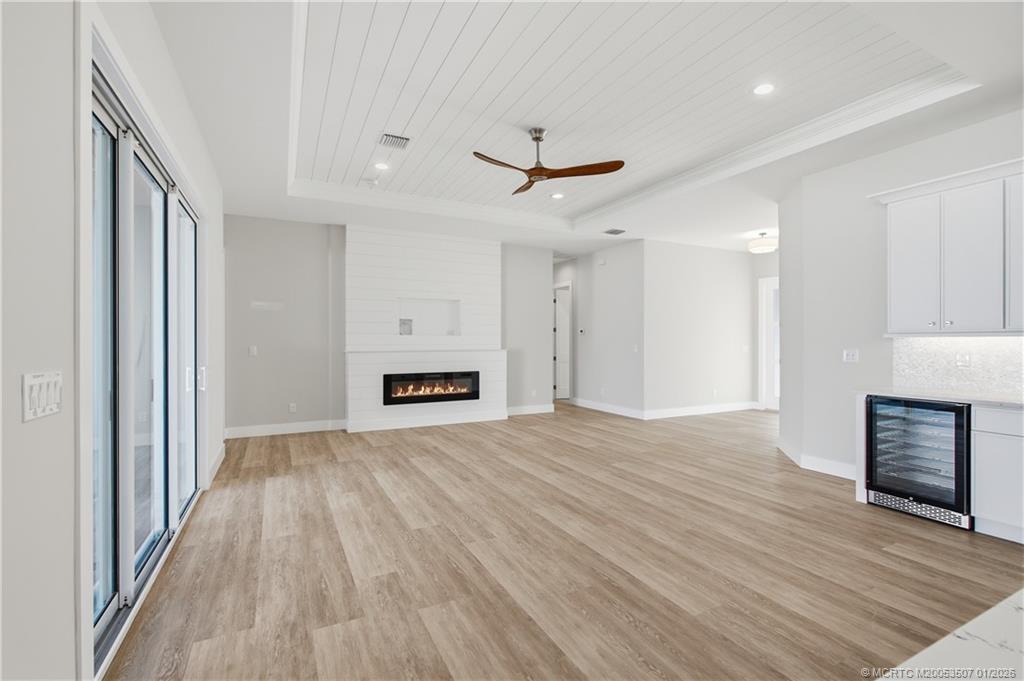 1063 Northwest 12th Terrace Stuart, FL 34994 - Photo 10 of 42 a view of empty room with wooden floor and window