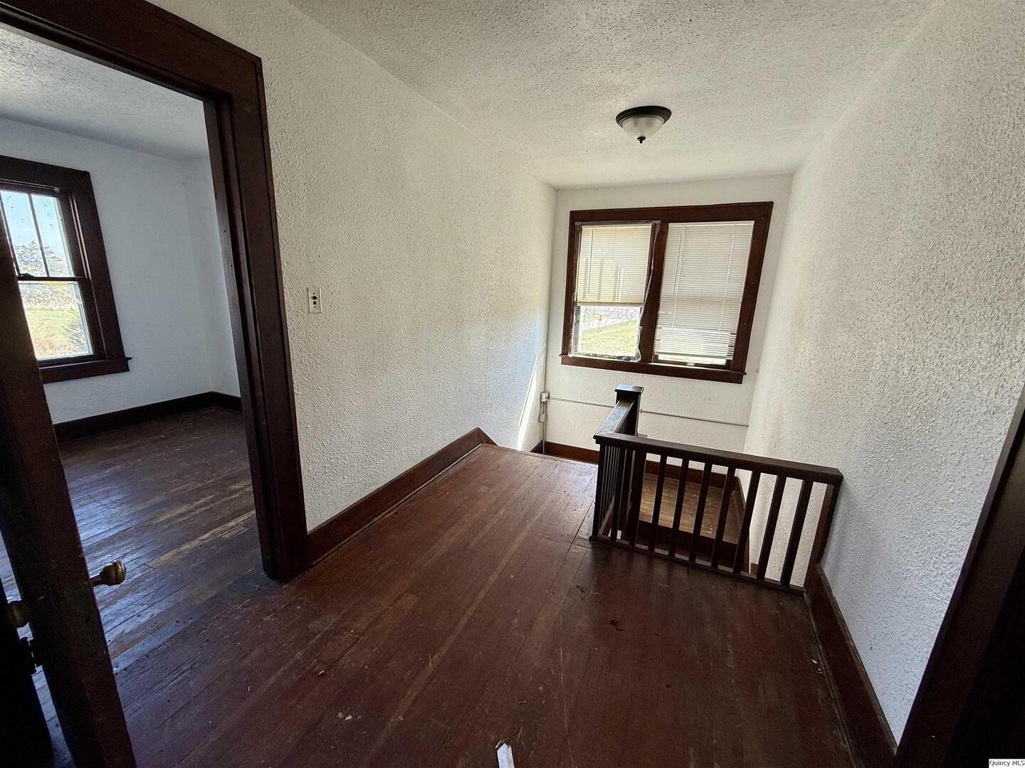 622 East Center Street Loraine, IL 62349 - Photo 16 of 21 a view of a hallway with wooden floor and stairs