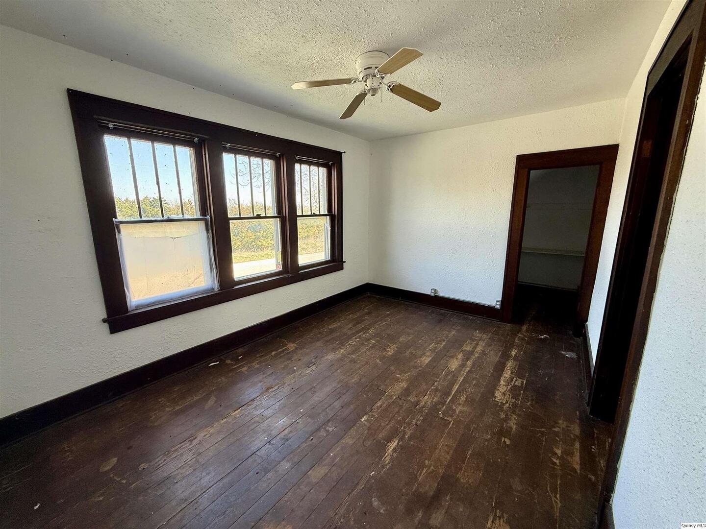 622 East Center Street Loraine, IL 62349 - Photo 17 of 21 a view of an empty room with a window and wooden floor