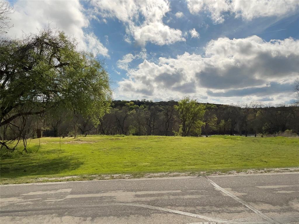 9314 Bellechase Road Granbury, TX 76049 - Photo 1 of 1 a view of a grassy field with an trees