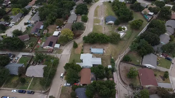 an aerial view of multiple houses with yard