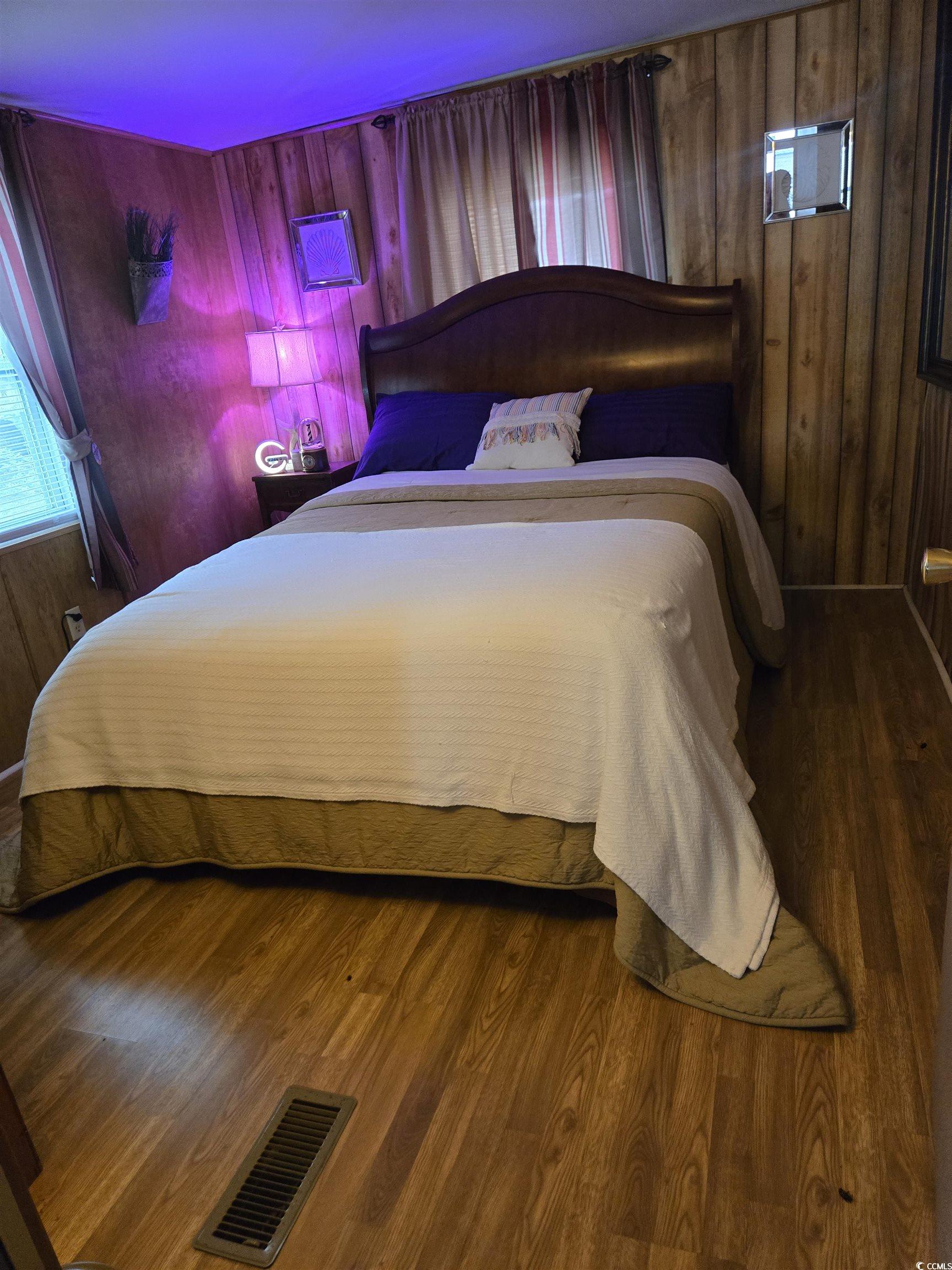 348 Bridge Street Murrells Inlet, SC 29576 - Photo 22 of 28 Bedroom with wood walls and wood finished floors