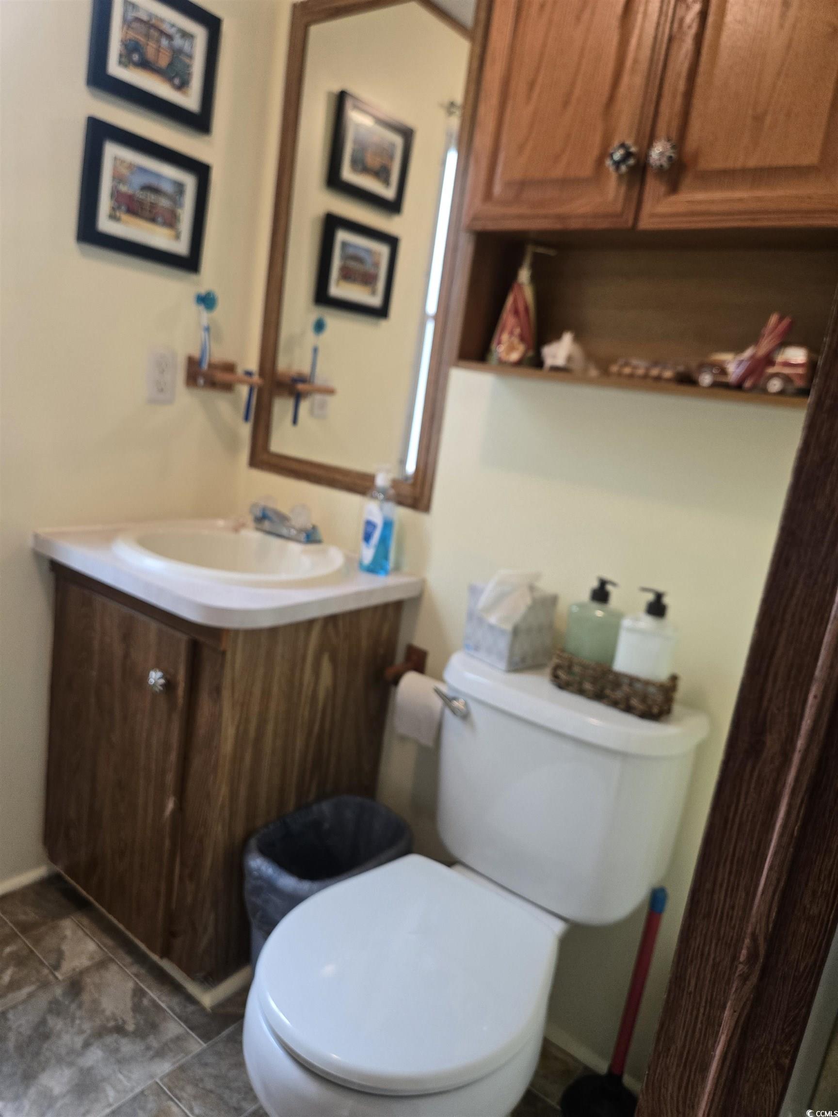 348 Bridge Street Murrells Inlet, SC 29576 - Photo 27 of 28 Bathroom with vanity, toilet, and baseboards