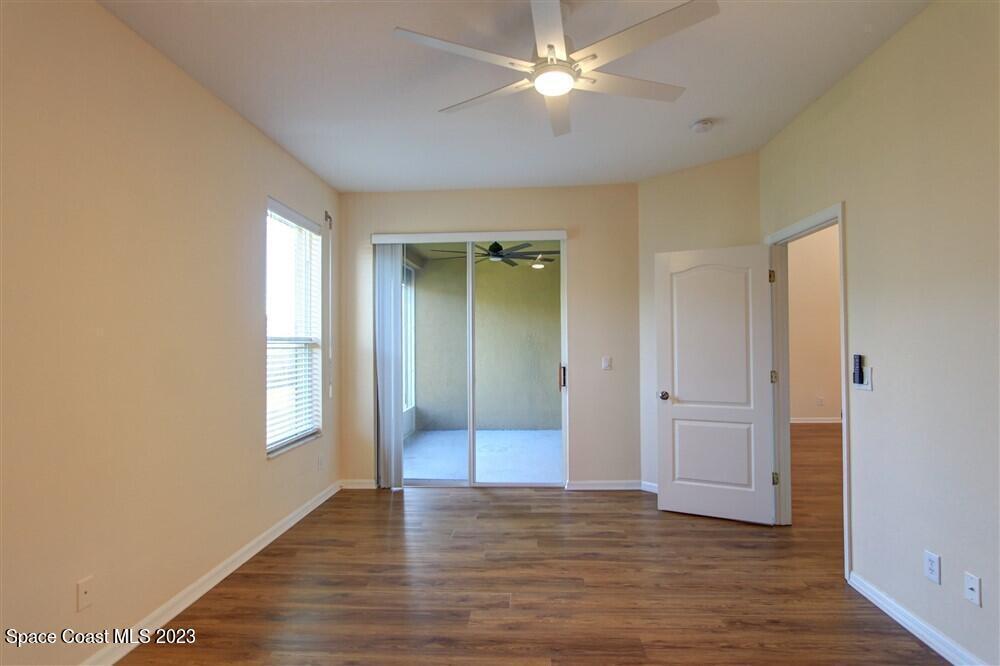 264 Intrepid Way Indialantic, FL 32903 - Photo 13 of 36 a view of an empty room with window and wooden floor