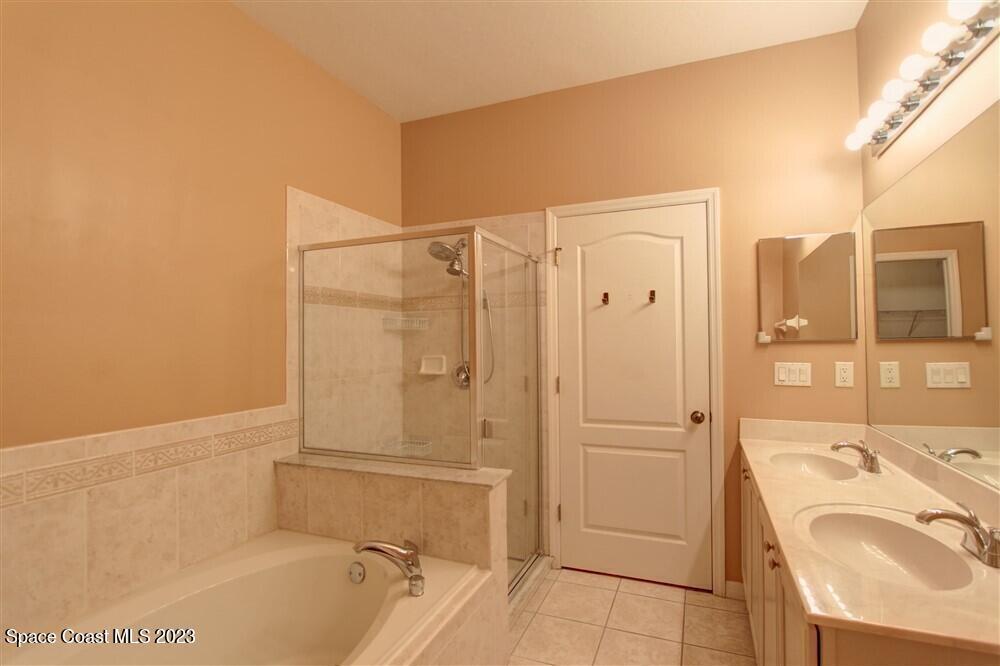 264 Intrepid Way Indialantic, FL 32903 - Photo 15 of 36 a bathroom with a tub a sink and a shower