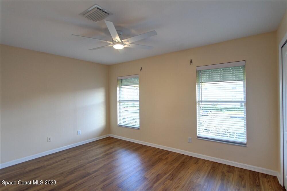 264 Intrepid Way Indialantic, FL 32903 - Photo 20 of 36 a view of an empty room with wooden floor and a window