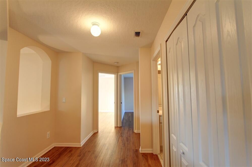 264 Intrepid Way Indialantic, FL 32903 - Photo 23 of 36 a view of a hallway with wooden floor