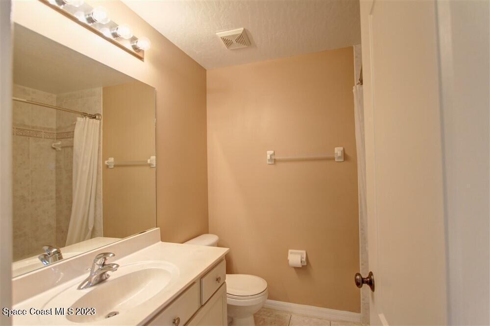264 Intrepid Way Indialantic, FL 32903 - Photo 24 of 36 a bathroom with a sink a toilet and shower