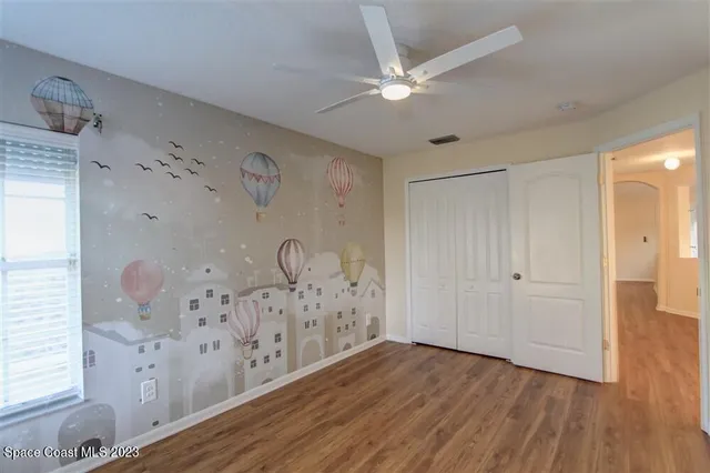 a view of a room with wooden floor