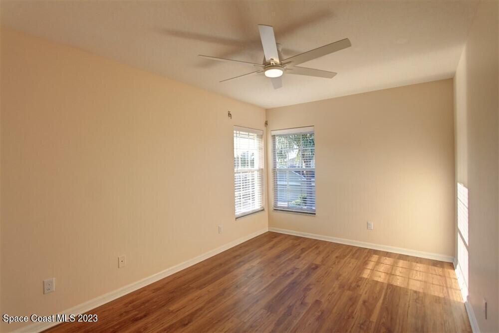 264 Intrepid Way Indialantic, FL 32903 - Photo 27 of 36 an empty room with wooden floor fan and windows