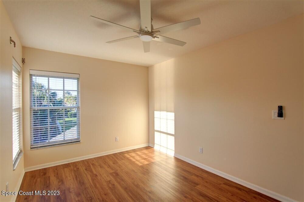 264 Intrepid Way Indialantic, FL 32903 - Photo 28 of 36 an empty room with wooden floor fan and windows