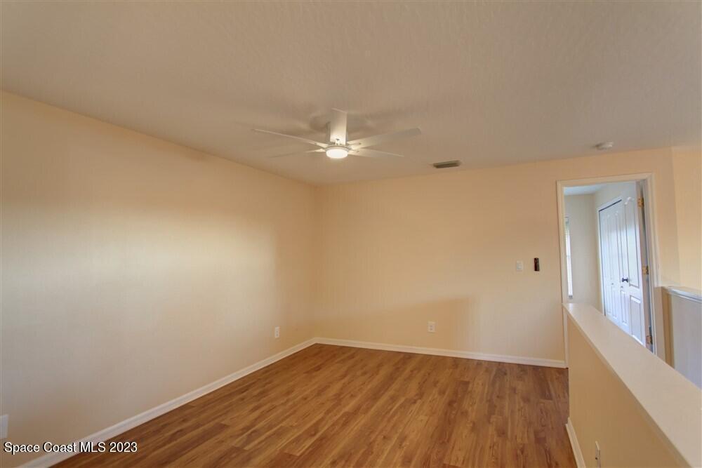 264 Intrepid Way Indialantic, FL 32903 - Photo 30 of 36 a view of a room with wooden floor and a chandelier fan
