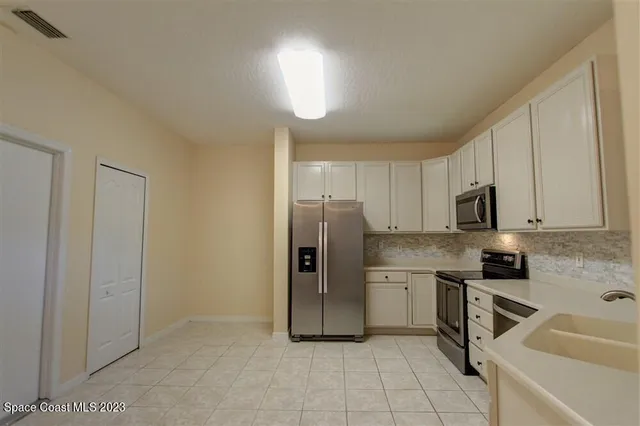 a kitchen with stainless steel appliances granite countertop a sink and cabinets
