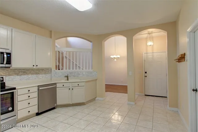 a spacious bathroom with a granite countertop sink mirror and a bathtub