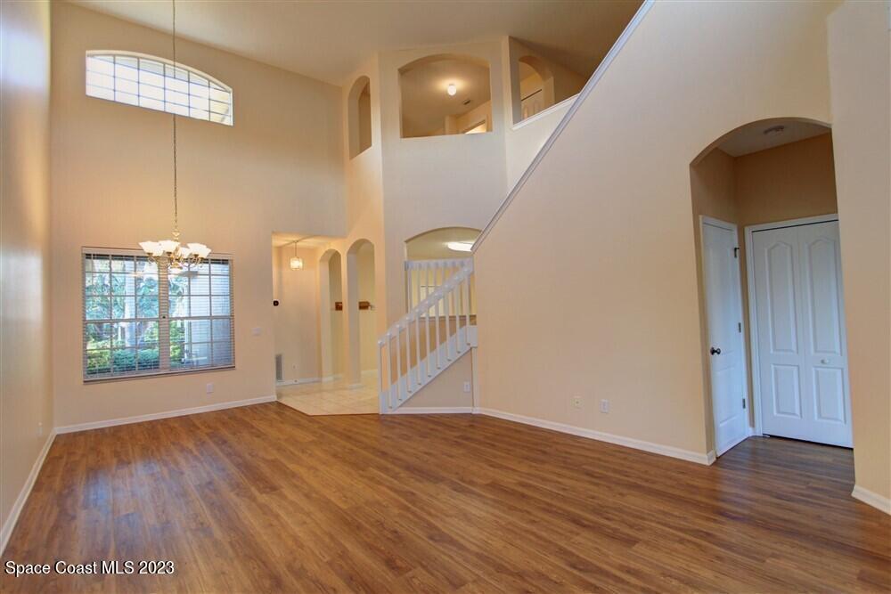 264 Intrepid Way Indialantic, FL 32903 - Photo 9 of 36 a view of an empty room with wooden floor and a window