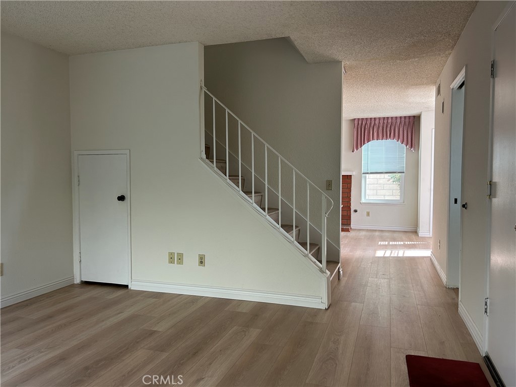 7221 Daybreak Place Rancho Cucamonga, CA 91701 - Photo 12 of 24 a view of a hallway with wooden floor and staircase