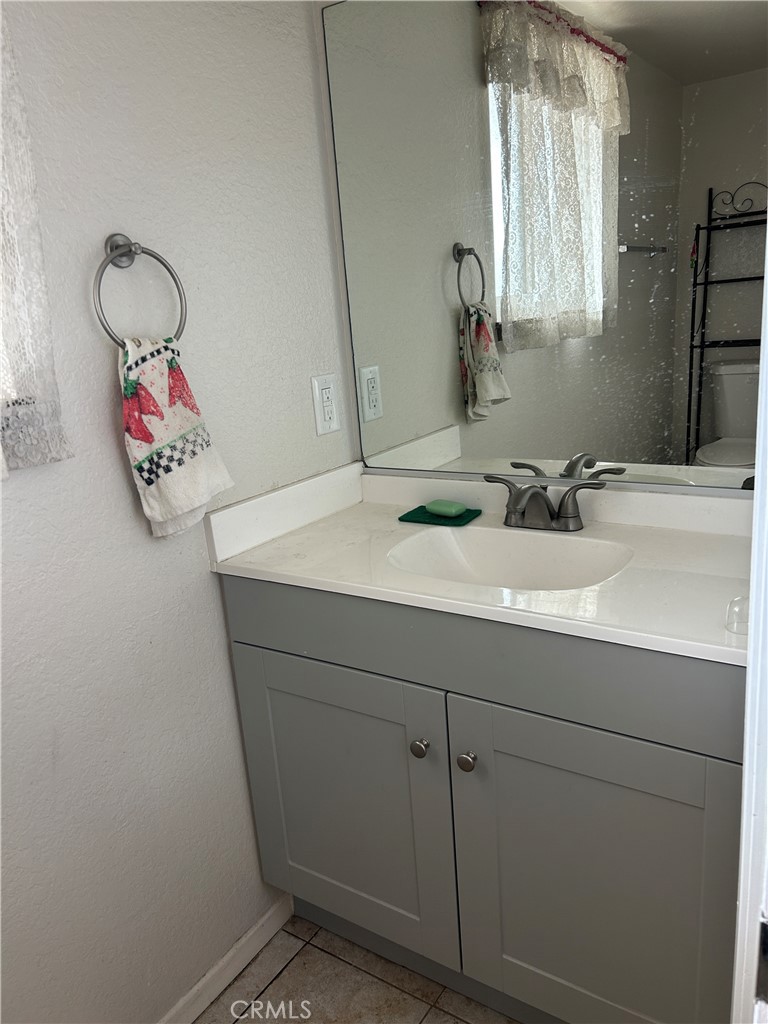 7221 Daybreak Place Rancho Cucamonga, CA 91701 - Photo 13 of 24 a bathroom with a sink and a mirror