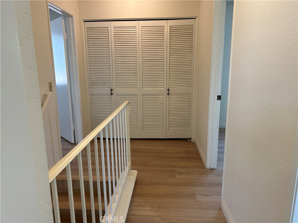7221 Daybreak Place Rancho Cucamonga, CA 91701 - Photo 15 of 24 a view of a hallway with wooden floor and staircase