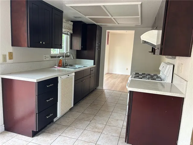 a kitchen with a sink and a stove top oven