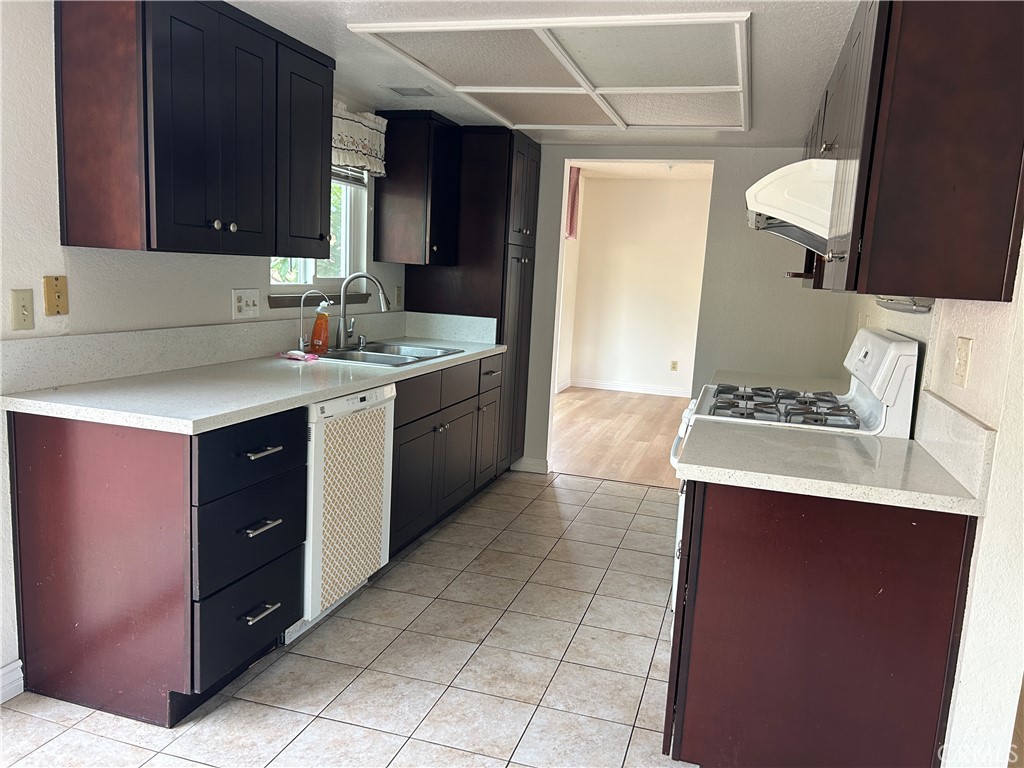 7221 Daybreak Place Rancho Cucamonga, CA 91701 - Photo 10 of 24 a kitchen with a sink and a stove top oven